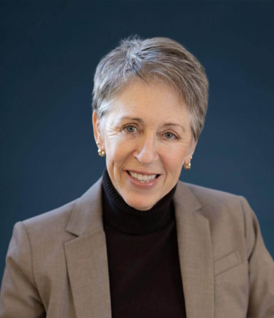 Smiling professional woman in a blazer, available at Ceek Next Innovations for innovative business solutions.